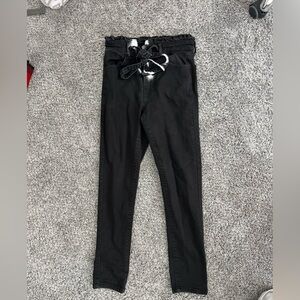 Black skinny jeans with tie and ruffle top